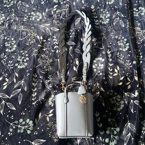 A small Tory Burch, light blueish gray, Crossbody/handbag brand new never used.